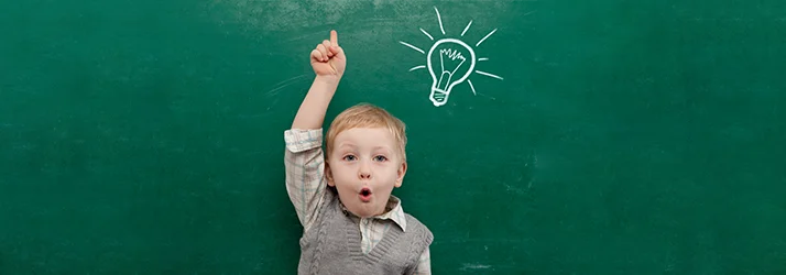 Little Child With A Question In Front Of Chalkboard